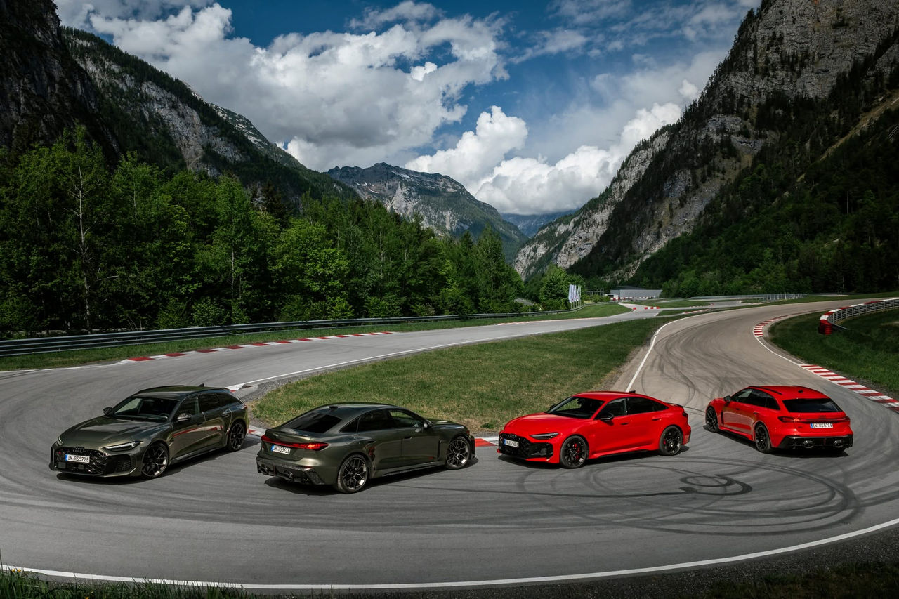 From left in the image: Audi RS 5 Avant in Bedford green, Audi RS 5 Sedan in Bedford green, Audi RS 5 Sedan in Progressive red, and Audi RS 5 Avant in Progressive red, outdoor static shot, exterior, in an alpine landscape.